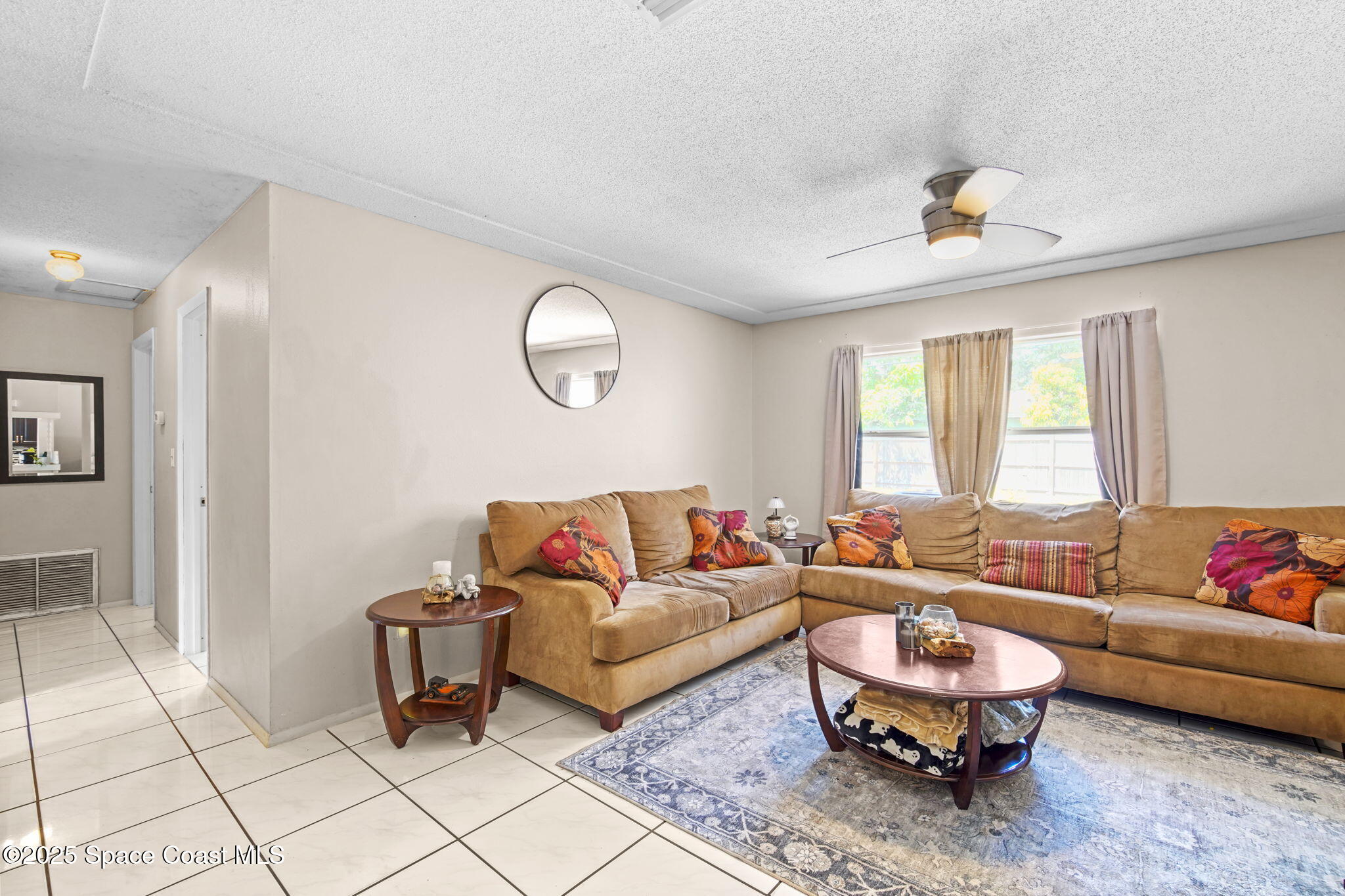 1044 Pompano Drive Rockledge, FL 32955 - Photo 6 of 28 a living room with furniture and a window