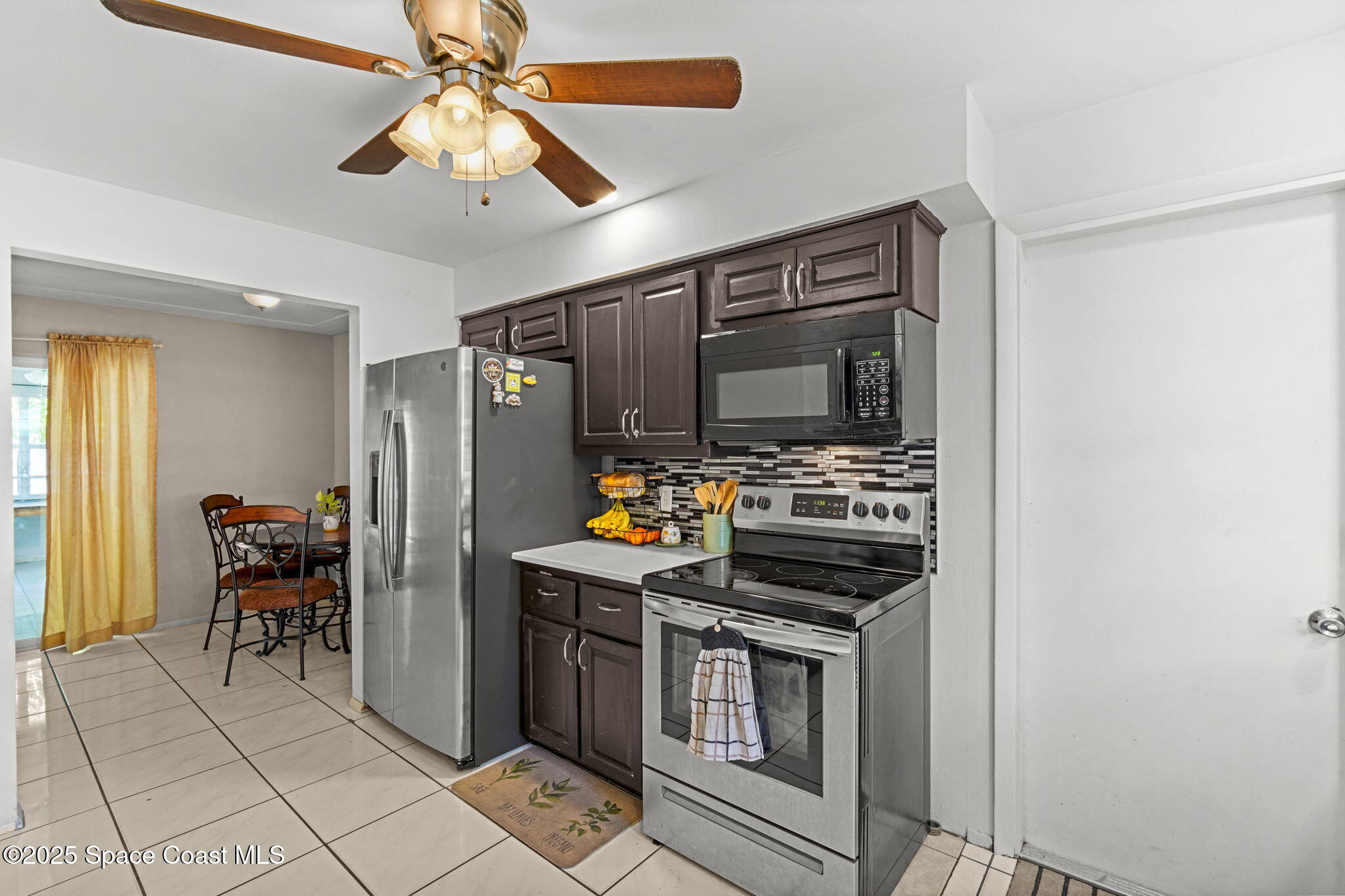 1044 Pompano Drive Rockledge, FL 32955 - Photo 10 of 28 a kitchen with stainless steel appliances a stove and a refrigerator