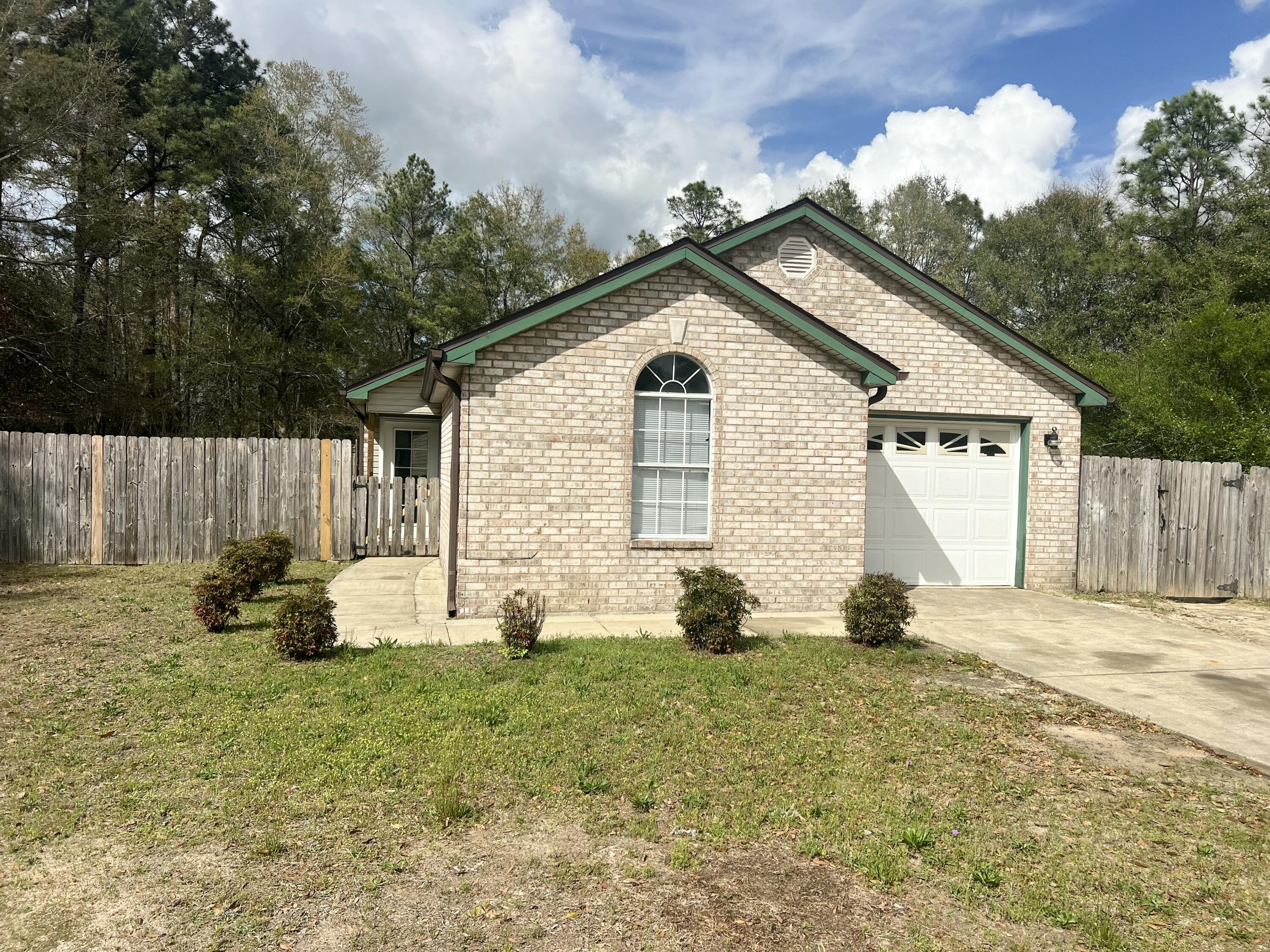 3429 Melissa Lane Crestview, FL 32539 - Photo 1 of 28 a view of a house with backyard and garden