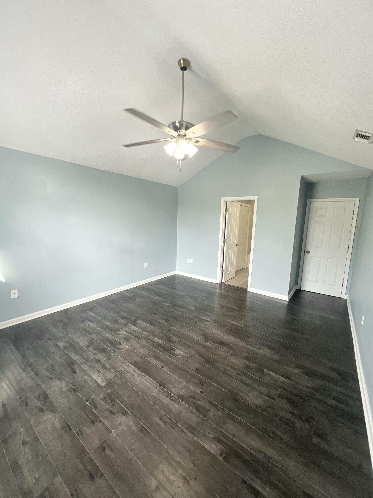 3429 Melissa Lane Crestview, FL 32539 - Photo 12 of 28 a view of empty room with wooden floor and ceiling fan