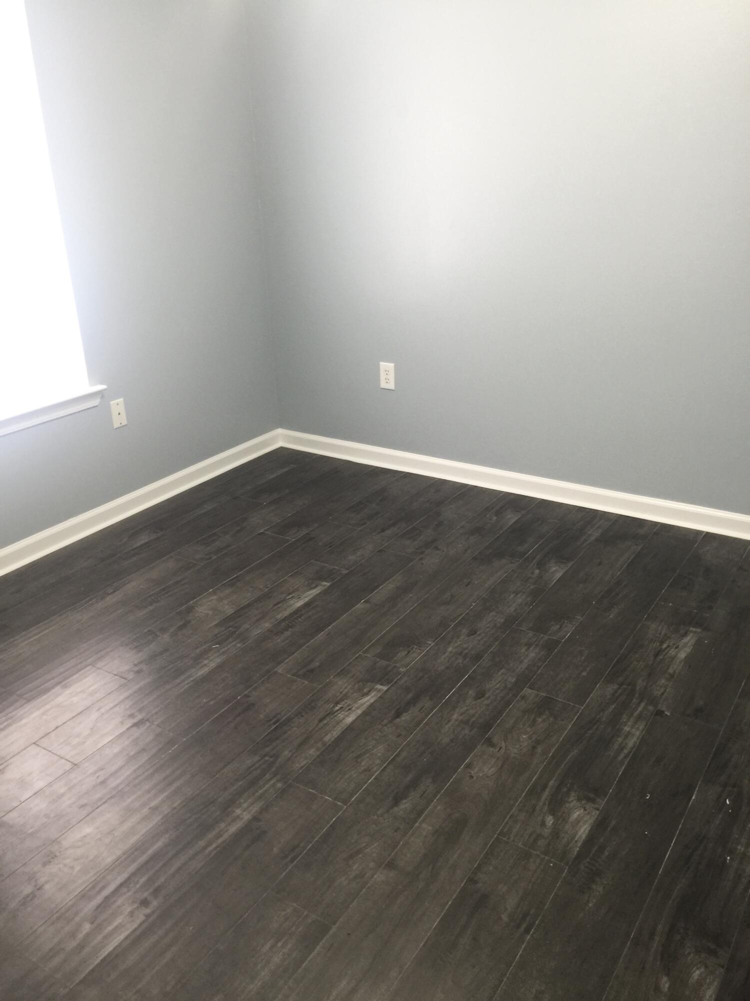 3429 Melissa Lane Crestview, FL 32539 - Photo 17 of 28 a view of an empty room with wooden floor and a window