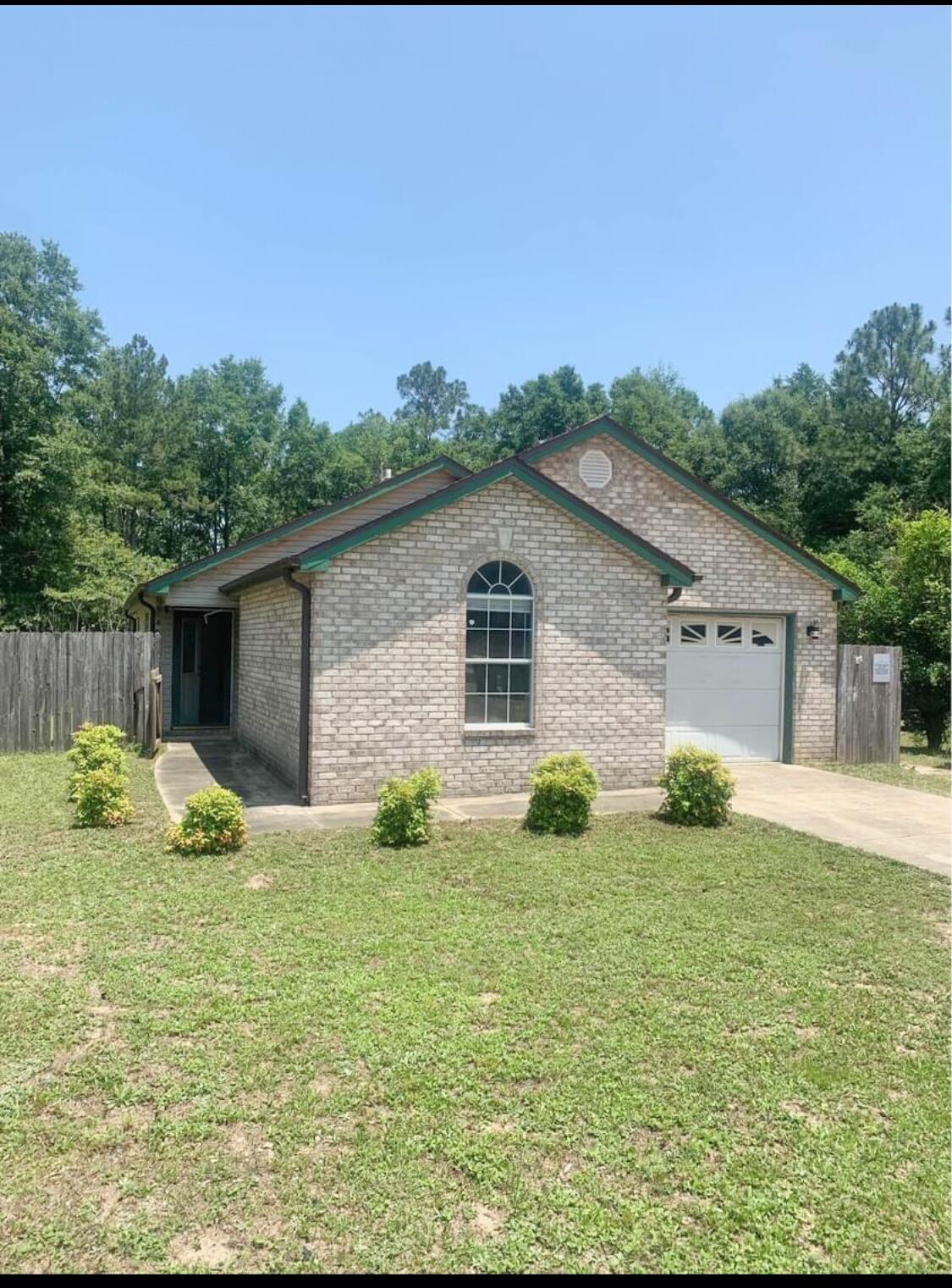 3429 Melissa Lane Crestview, FL 32539 - Photo 2 of 28 a view of a backyard with table and chairs and wooden fence