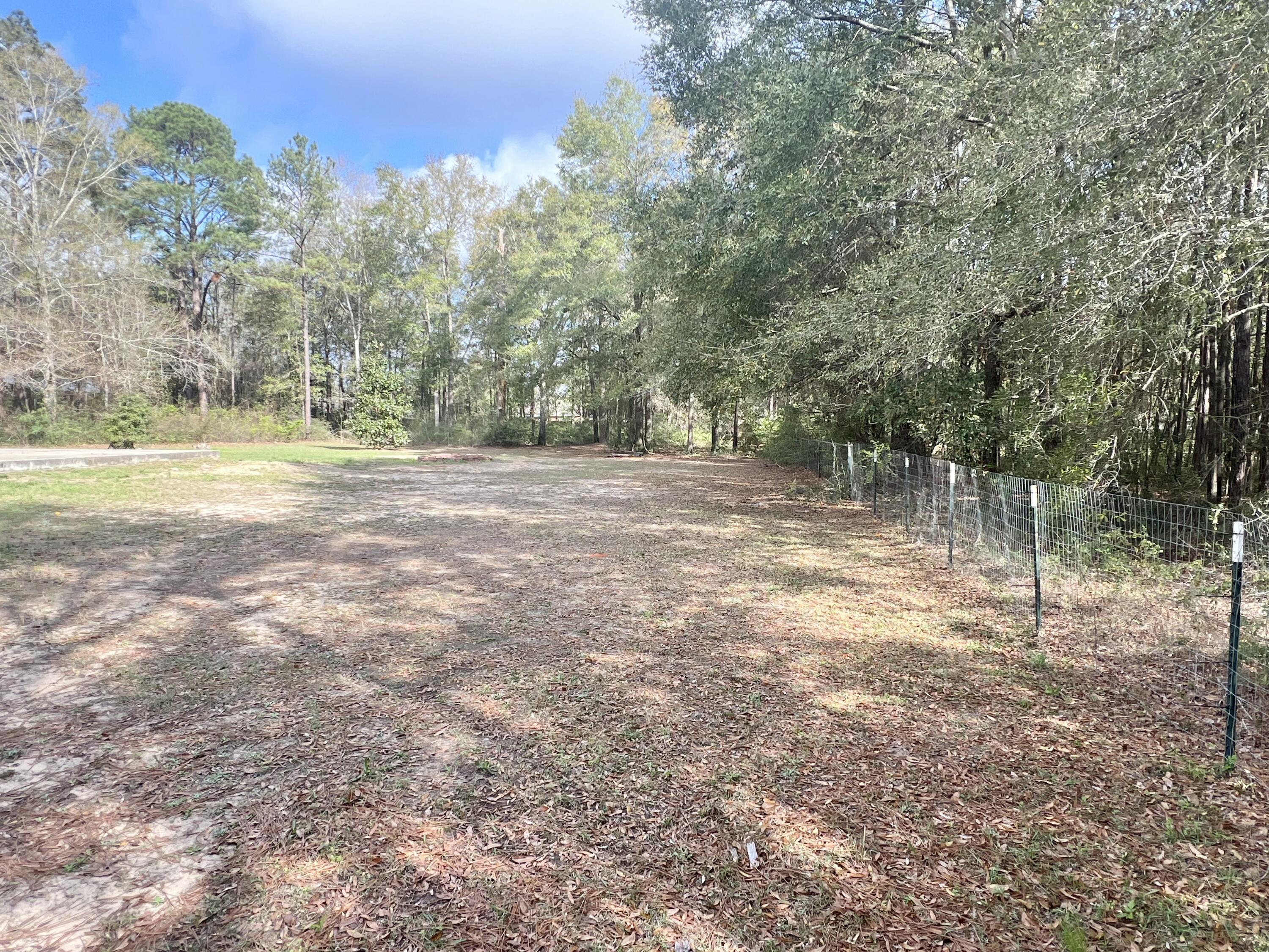 3429 Melissa Lane Crestview, FL 32539 - Photo 23 of 28 a view of a yard with trees in the background
