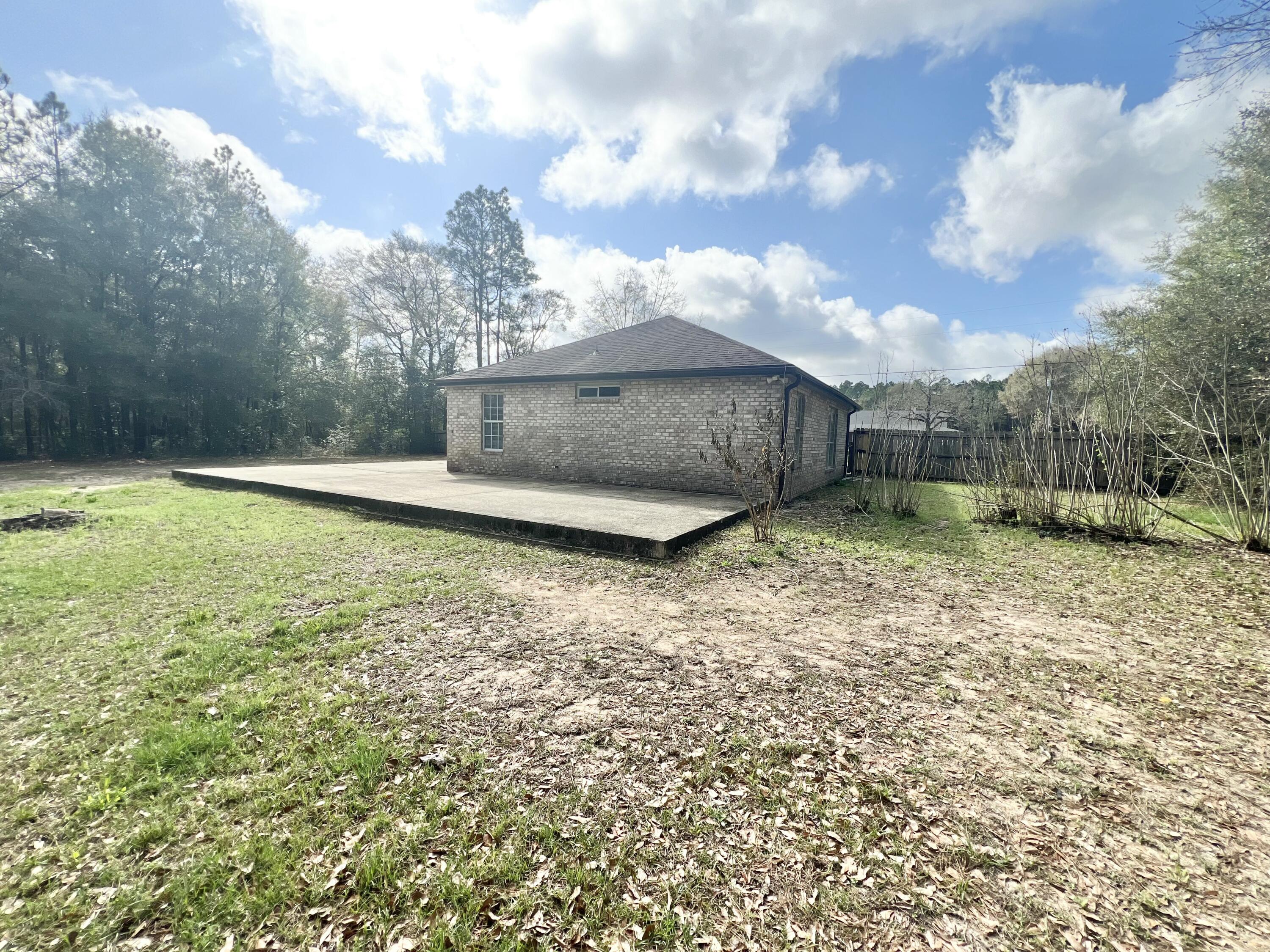 3429 Melissa Lane Crestview, FL 32539 - Photo 26 of 28 a view of a backyard with large trees