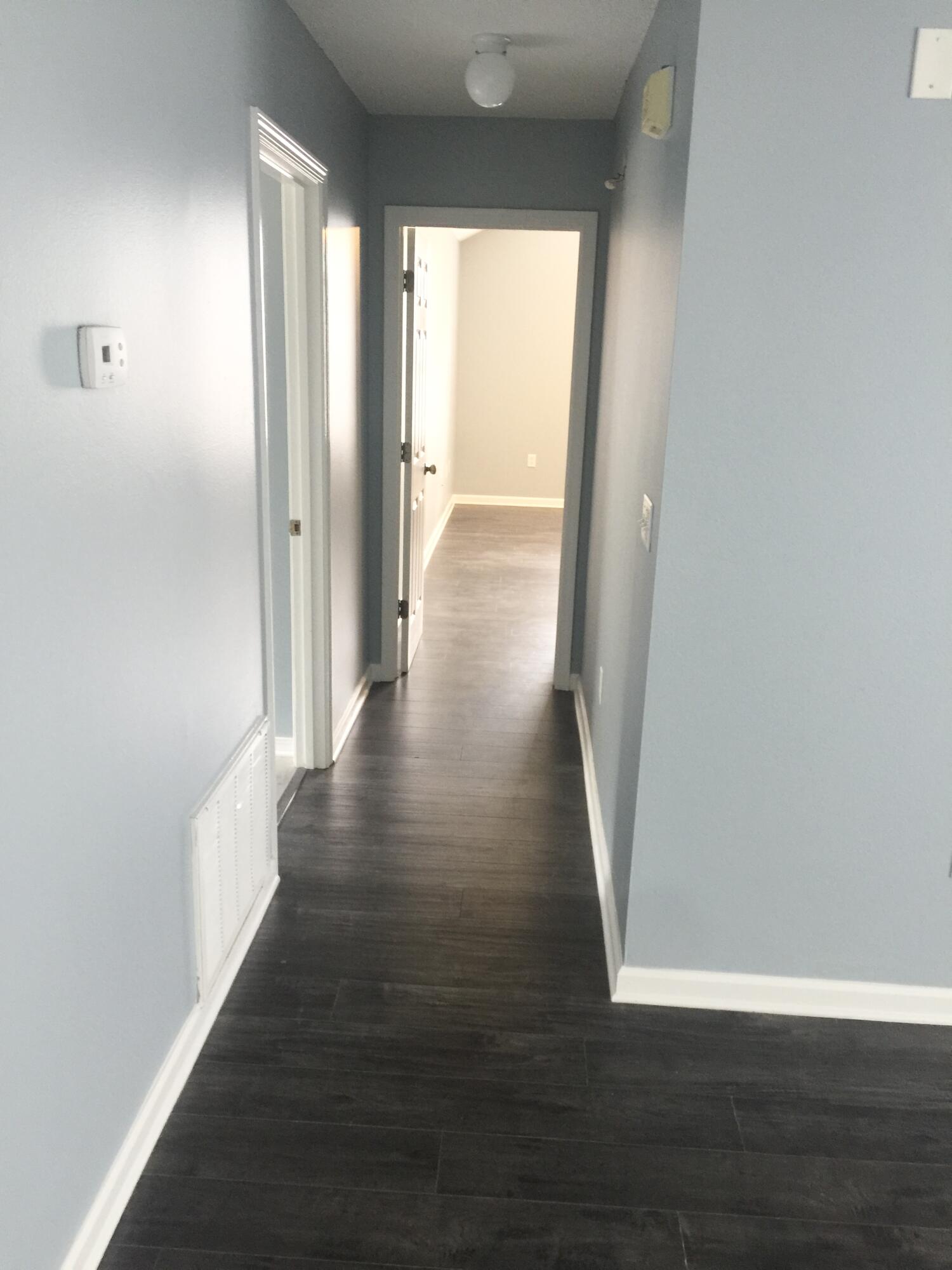 3429 Melissa Lane Crestview, FL 32539 - Photo 6 of 28 a view of a hallway with wooden floor