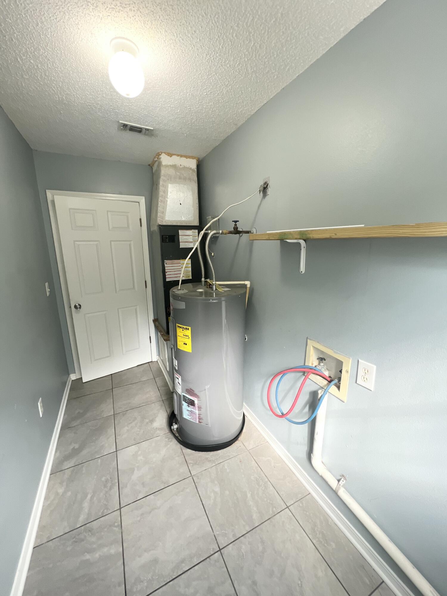 3429 Melissa Lane Crestview, FL 32539 - Photo 9 of 28 a view of storage and utility room with racks on the wall