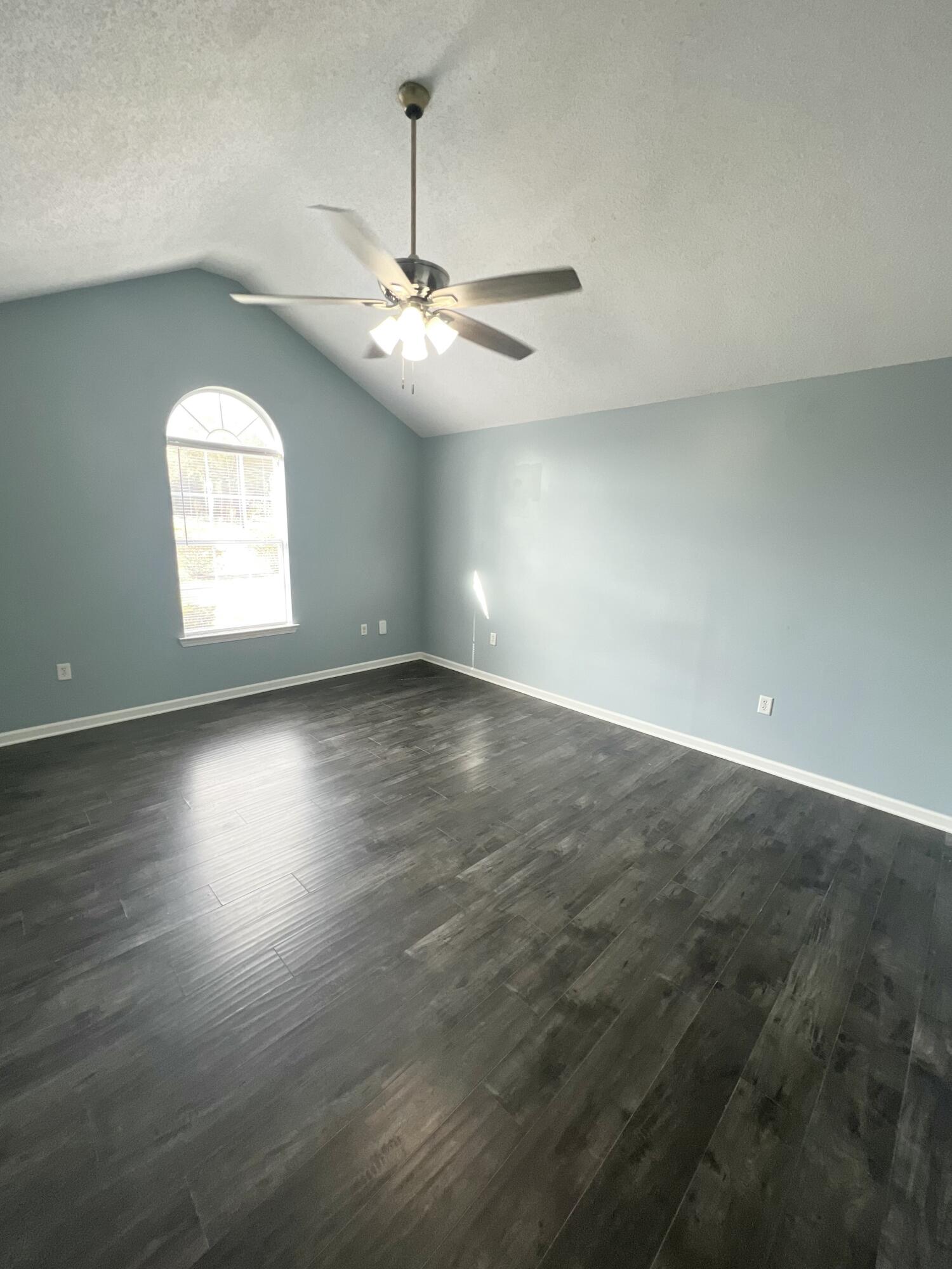 3429 Melissa Lane Crestview, FL 32539 - Photo 10 of 28 an empty room with wooden floor chandelier fan and windows