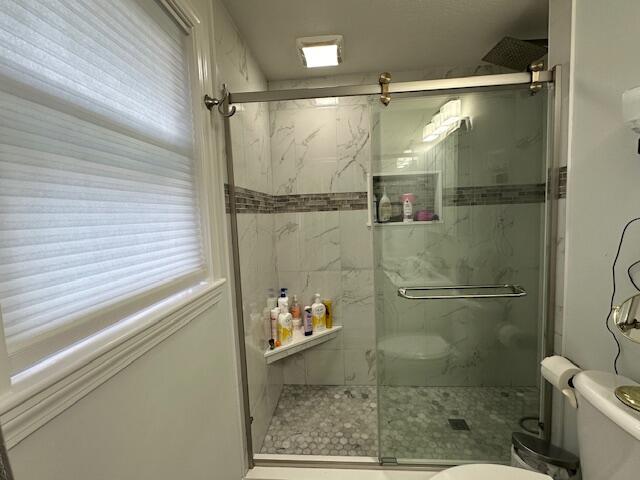89 Mitchells Way Hyannis, MA 02601 - Photo 17 of 33 a bathroom with a glass shower door