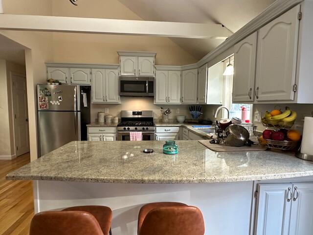 89 Mitchells Way Hyannis, MA 02601 - Photo 3 of 33 a kitchen with stainless steel appliances granite countertop a sink a stove and a refrigerator