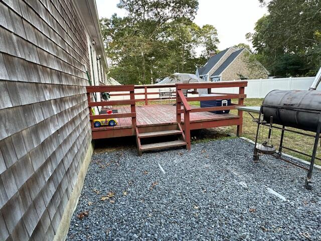 89 Mitchells Way Hyannis, MA 02601 - Photo 31 of 33 a backyard of a house with barbeque oven and a table and chairs