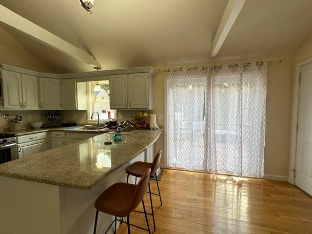 89 Mitchells Way Hyannis, MA 02601 - Photo 6 of 33 a large kitchen with granite countertop a stove a sink and a granite counter tops