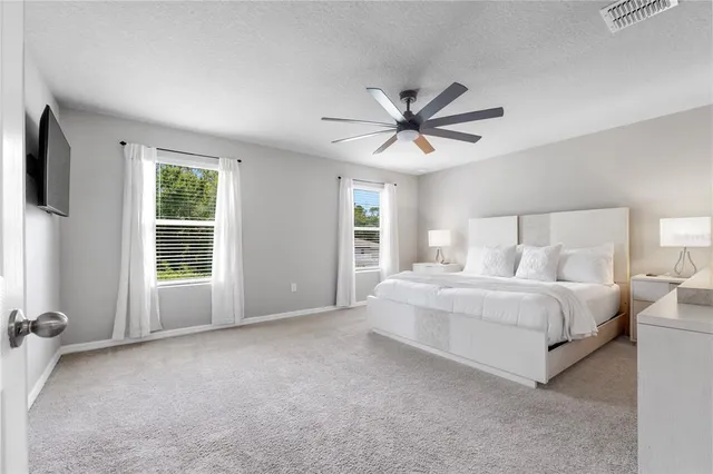 a spacious bedroom with a large bed and a window