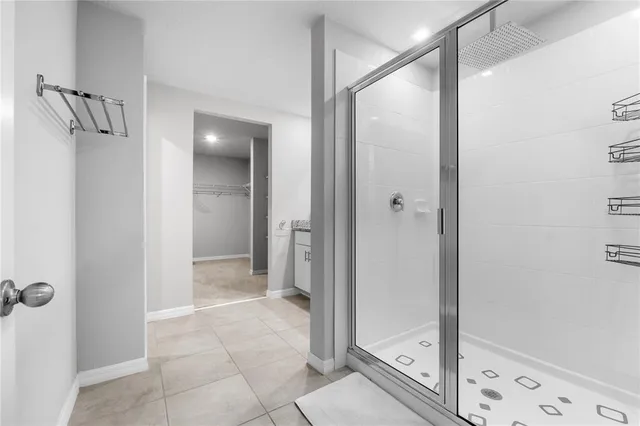 a bathroom with a glass shower door and a glass door