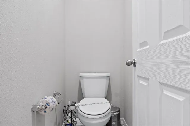 a white toilet sitting next to a shower