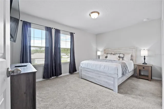 a bathroom with a granite countertop sink a toilet and a mirror