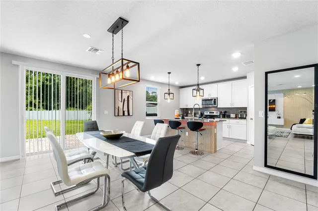 a living room with patio furniture and a wooden floor