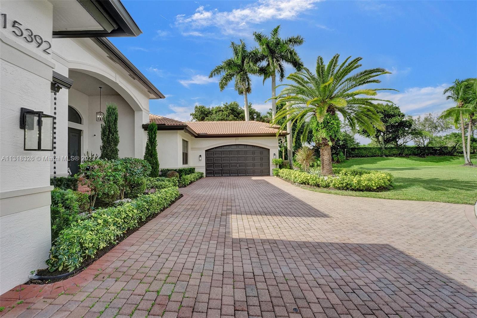 Davie Davie, FL 33331 - Photo 12 of 84 a front view of a house with a yard and potted plants