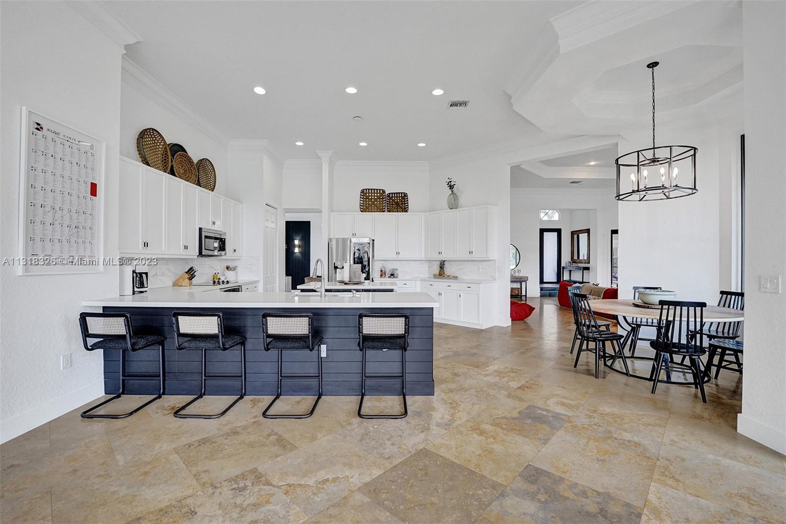 Davie Davie, FL 33331 - Photo 31 of 84 a view of dining room and livingroom with furniture wooden floor a rug a painting and a chandelier