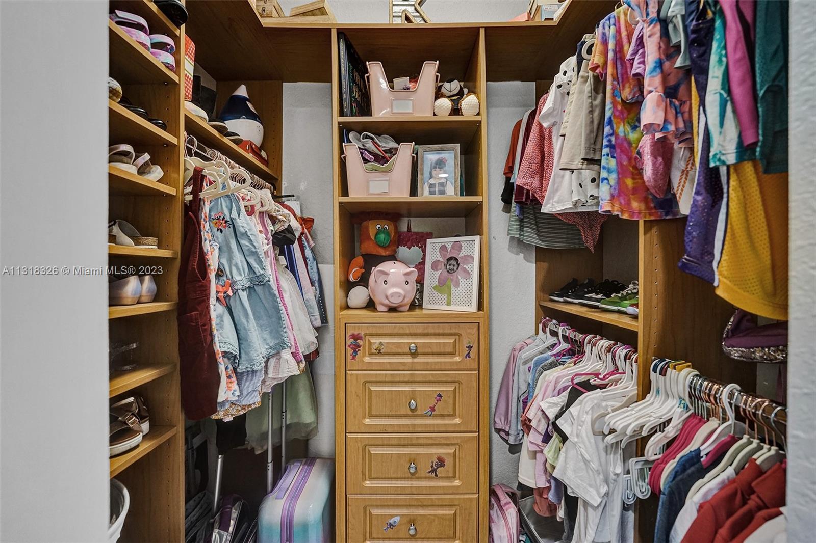 Davie Davie, FL 33331 - Photo 47 of 84 a view of walk in closet with clothes and shoes