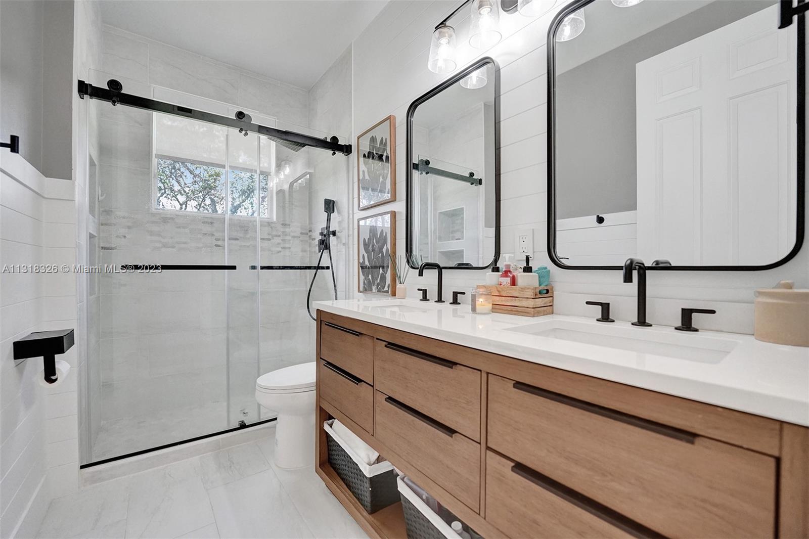 Davie Davie, FL 33331 - Photo 67 of 84 a bathroom with a double vanity sink mirror and shower