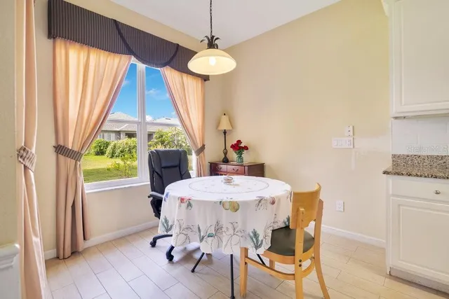 a dining room with furniture a chandelier and wooden floor