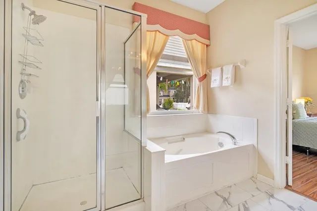 a bathroom with a tub and a window