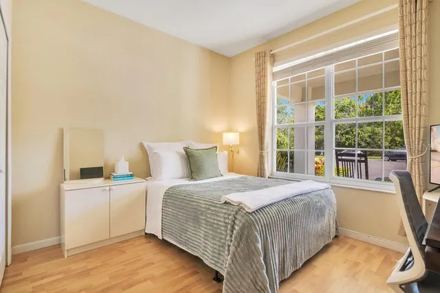 a bedroom with a large bed and a window