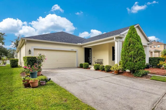 a front view of a house with garden and plants