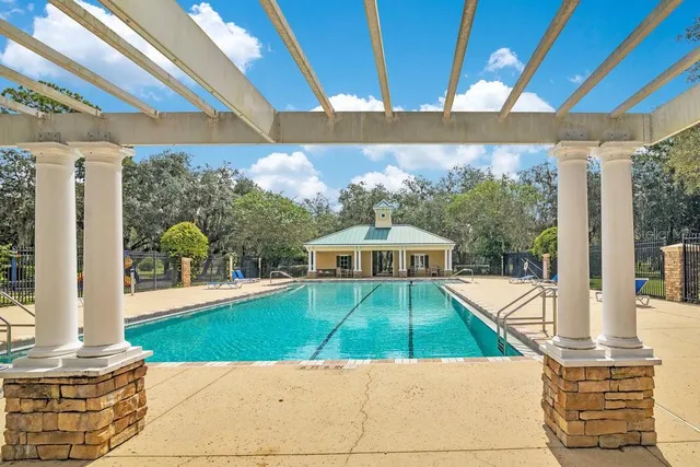 a view of a patio with a table and chairs under an umbrella