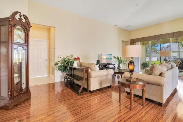 a living room with furniture a fireplace and wooden floor