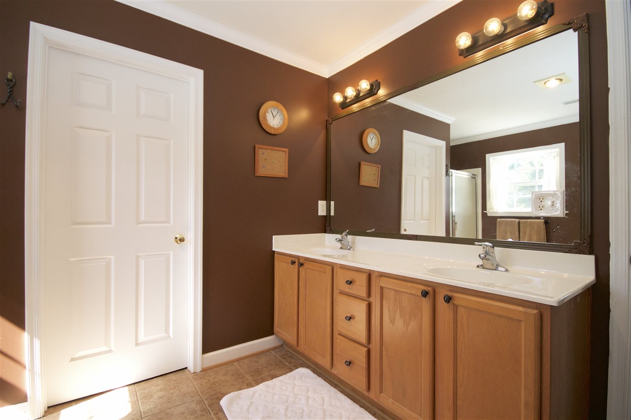 33 Haversack Road Palmyra, VA 22963 - Photo 15 of 22 a bathroom with a double vanity sink and a mirror