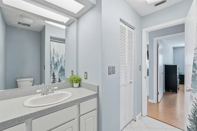a bathroom with a shower curtain and a sink
