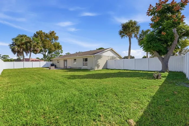 a view of a house with a backyard