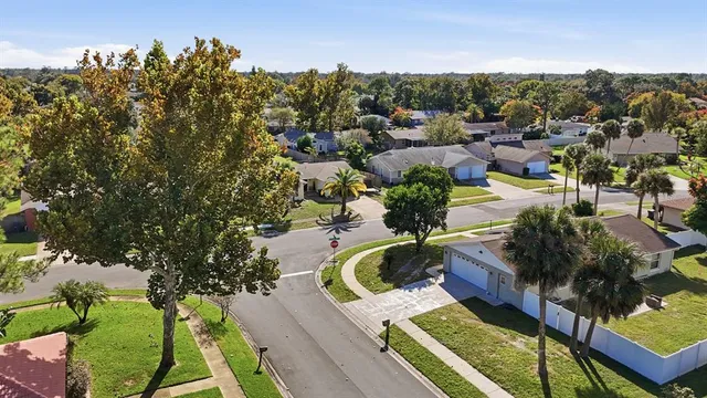 an aerial view of residential houses with outdoor space and street view