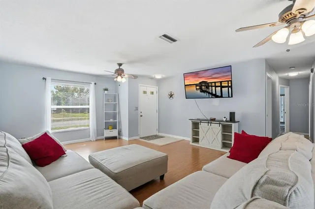 a living room with furniture and wooden floor