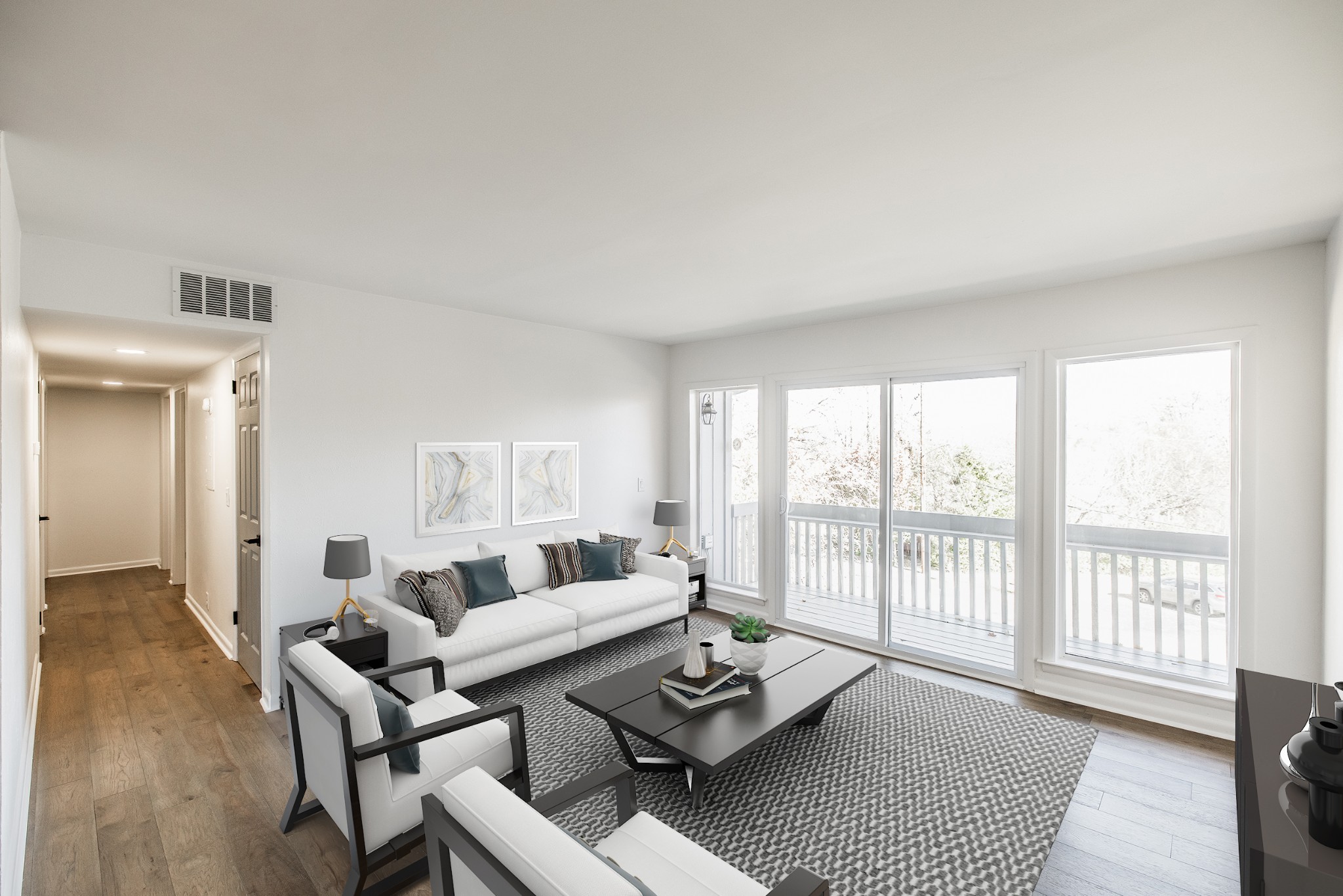 a living room with furniture and a floor to ceiling window