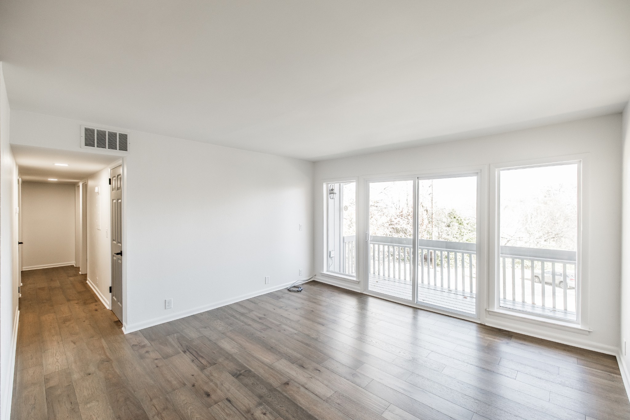 21 Vaughns Gap Road, Unit 55 Nashville, TN 37205 - Photo 4 of 35 an empty room with wooden floor and windows
