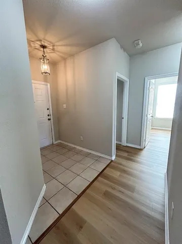 a view of a room with wooden floor and windows