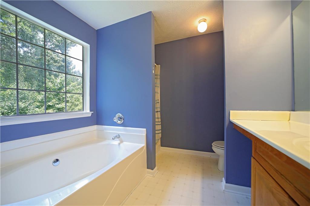 6874 Mahonia Place Lithonia, GA 30038 - Photo 14 of 27 a bathroom with a tub and a sink