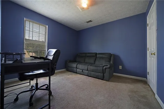 a livingroom with workspace and a window