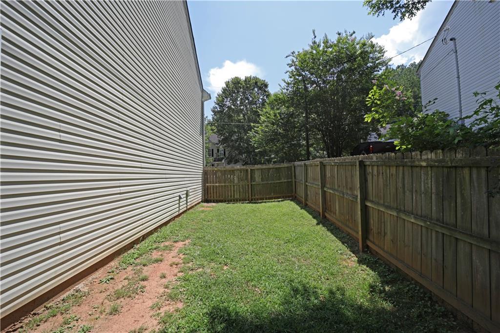 6874 Mahonia Place Lithonia, GA 30038 - Photo 26 of 27 a view of backyard with green space