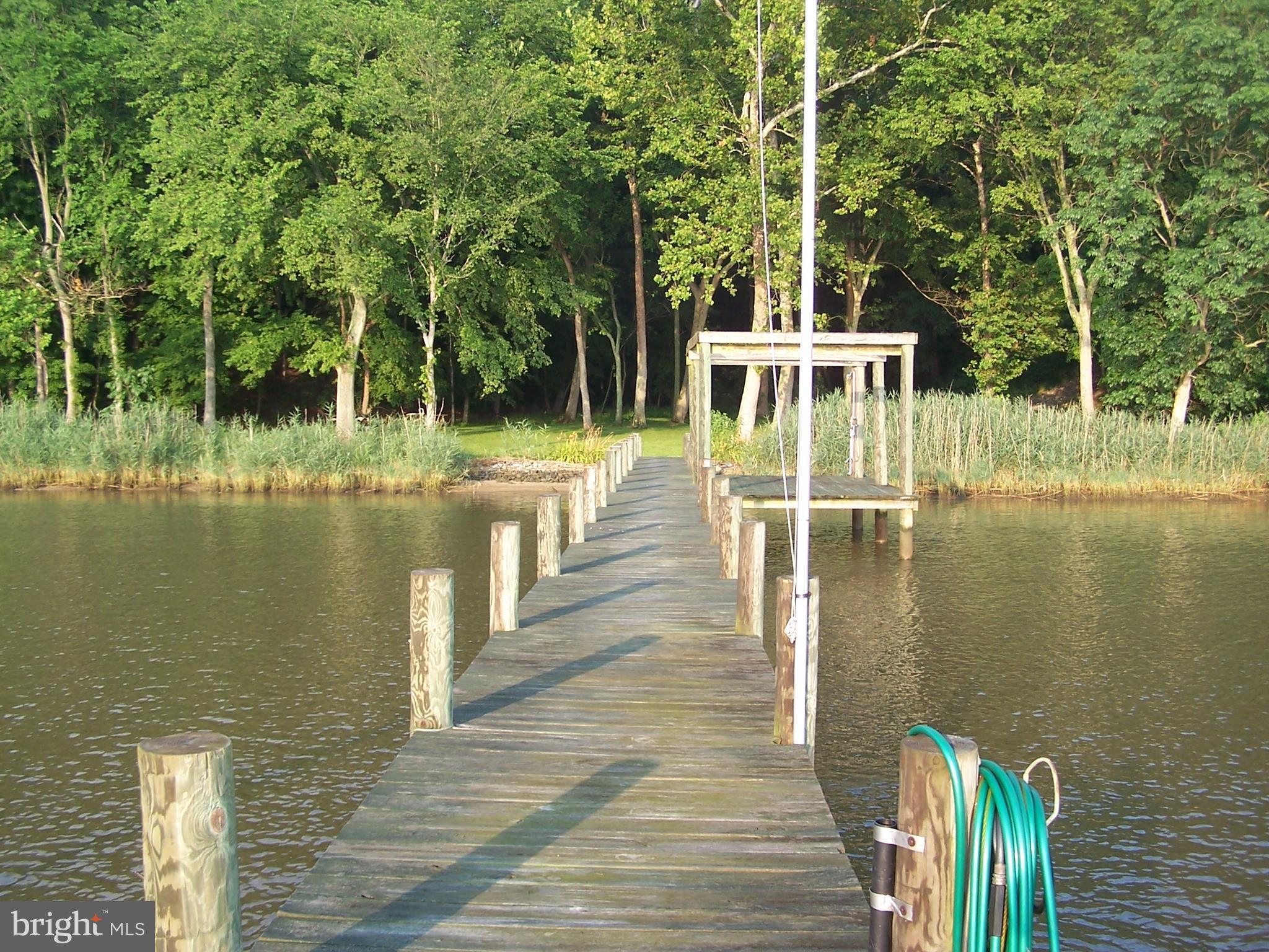 3025 Holland Cliffs Road Huntingtown, MD 20639 - Photo 9 of 12 a view of a lake with boats in front of house