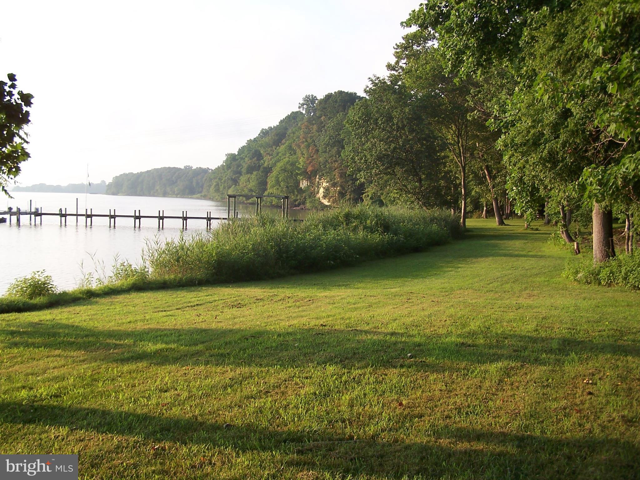 3025 Holland Cliffs Road Huntingtown, MD 20639 - Photo 10 of 12 a view of a lake with a big yard