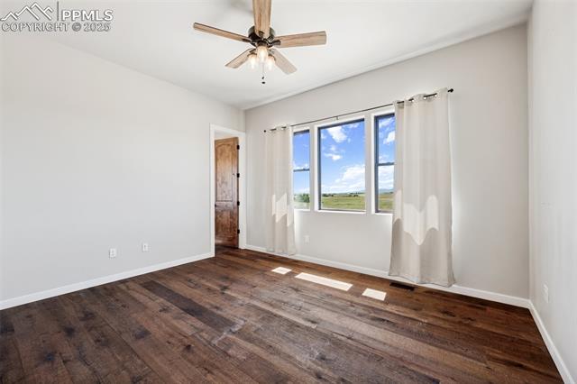 24365 Murphy Road Calhan, CO 80808 - Photo 31 of 48 Unfurnished room featuring ceiling fan and dark wood-style floors