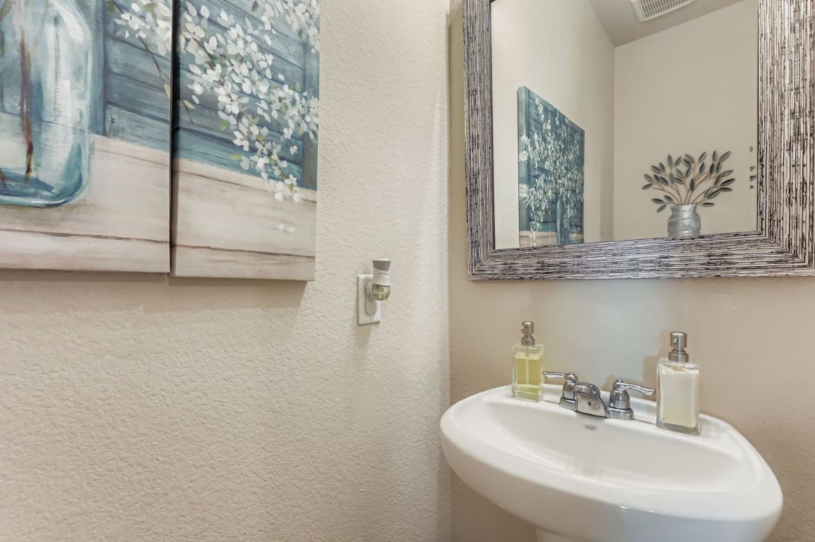 19433 Colgin Drive Pflugerville, TX 78660 - Photo 16 of 29 a bathroom with a sink and a mirror