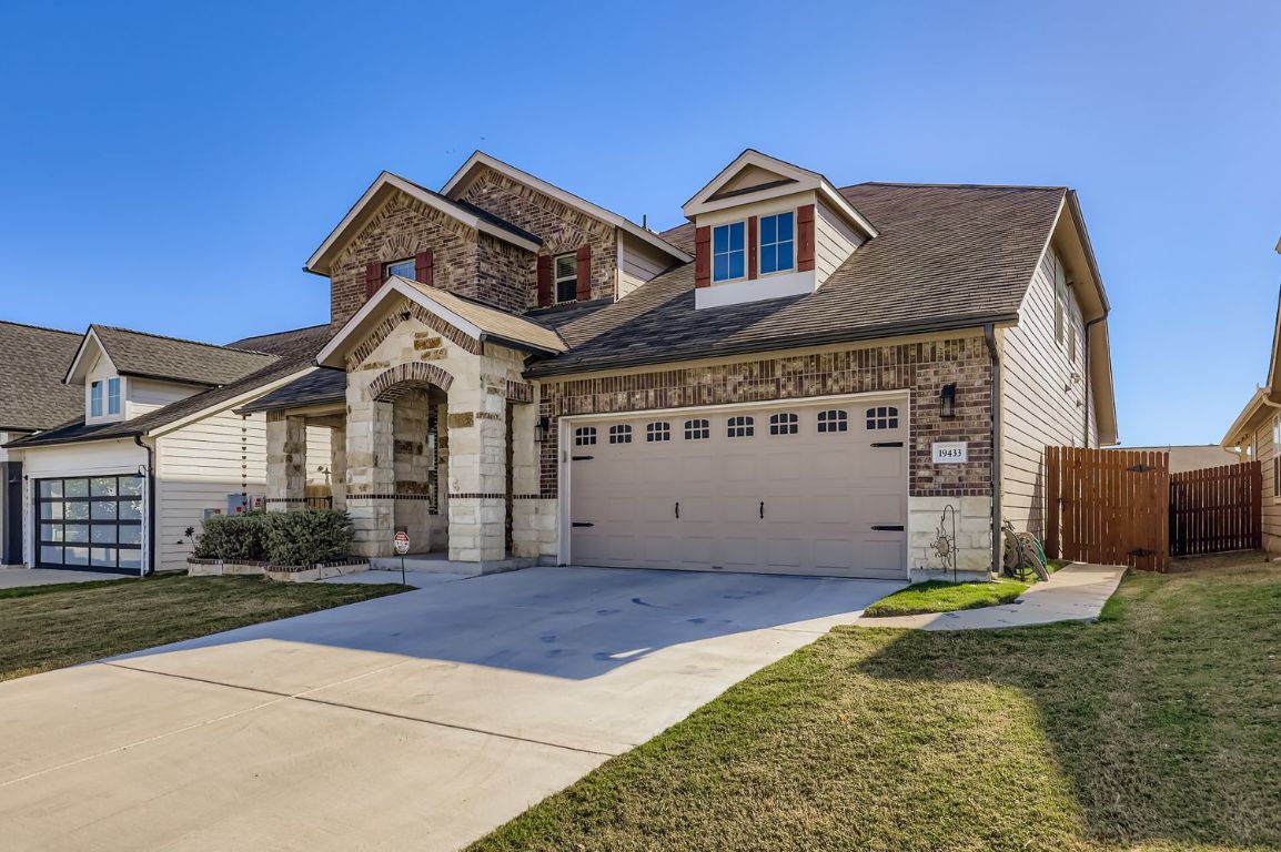 19433 Colgin Drive Pflugerville, TX 78660 - Photo 2 of 29 a front view of a house with a garden and yard