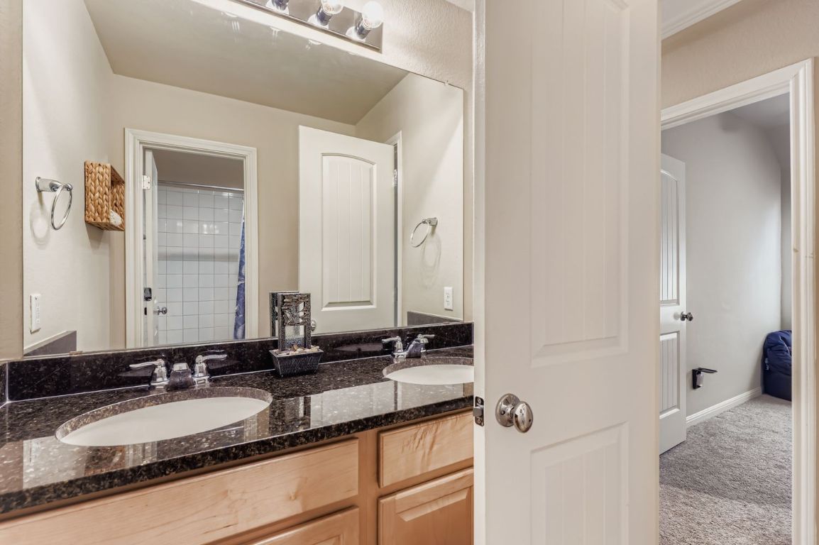 19433 Colgin Drive Pflugerville, TX 78660 - Photo 19 of 29 a bathroom with a granite countertop sink and a mirror