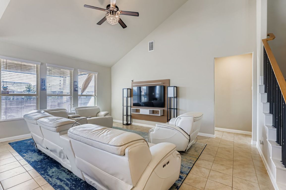 19433 Colgin Drive Pflugerville, TX 78660 - Photo 4 of 29 a living room with furniture and a flat screen tv