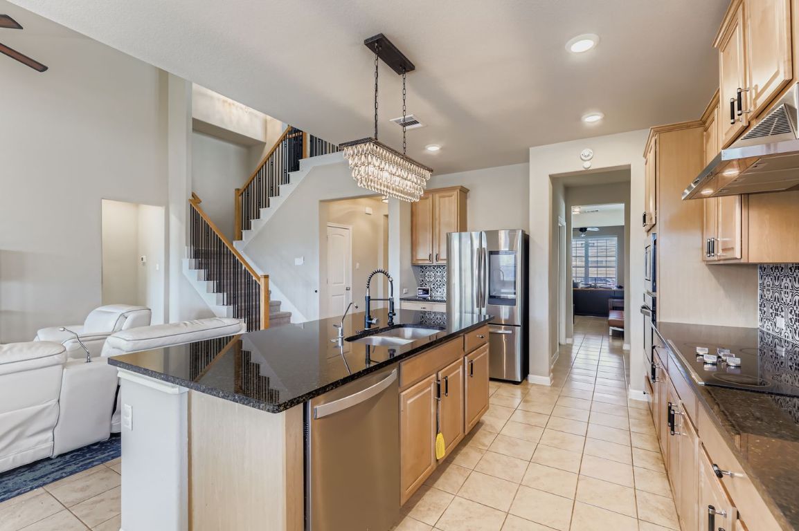 19433 Colgin Drive Pflugerville, TX 78660 - Photo 29 of 29 a kitchen with granite countertop a sink and cabinets
