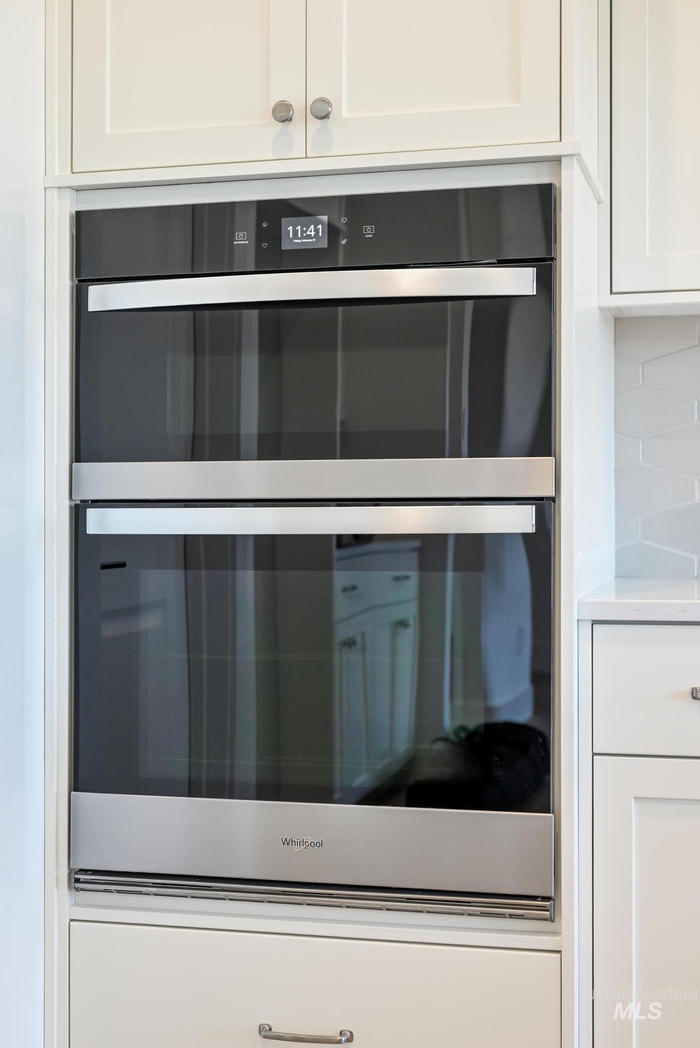 9800 West Novato Street Star, ID 83669 - Photo 13 of 40 Kitchen view of stainless steel double oven and white cabinets